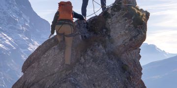 Bergsteiger beim Klettern auf felsspitze
