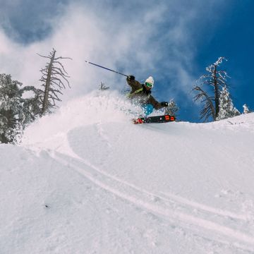 Ein Skifahrer geniesst die perfekten Schneeverhältnisse in Zermatt und carvt Schwünge in den frischen Pulverschnee.
